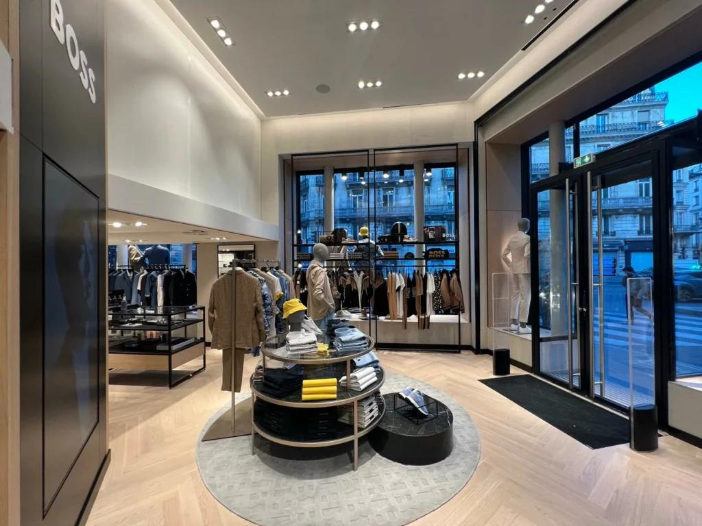 Entrée d’une boutique BOSS avec façade vitrée, signalétique de marque et espace retail