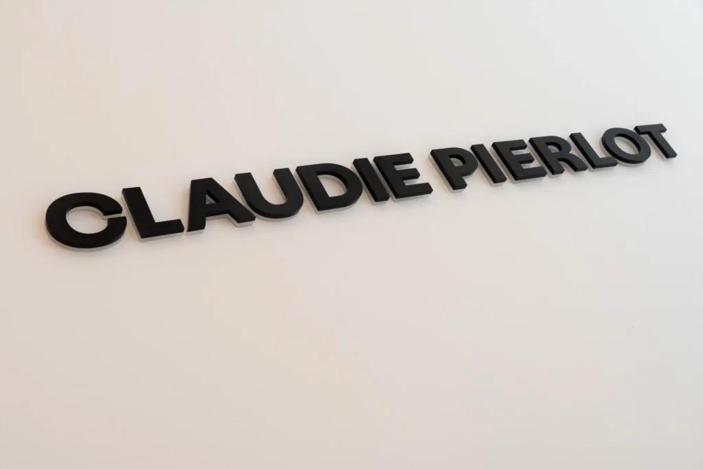 Vue de face de la boutique Claudie Pierlot Grenoble avec mobilier retail, portants et ambiance élégante