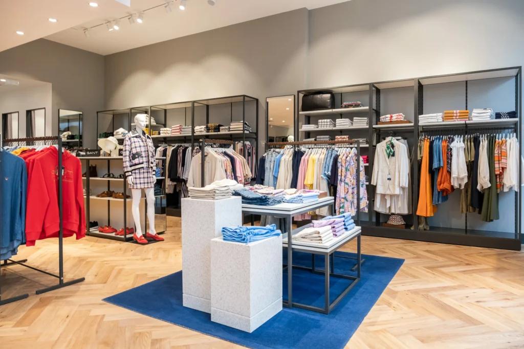 Présentoirs centraux et linéaires muraux dans une boutique GANT aménagée par L2A Agencement