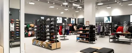 Intérieur du magasin Foot Locker Bobigny avec mobilier retail, sneakers, vêtements et éclairage moderne