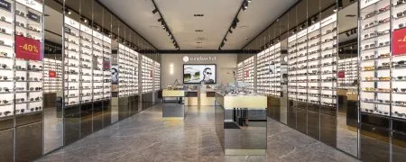 Intérieur de la boutique SUNGLASS Villefontaine avec mobilier retail, lunettes et identité visuelle de marque