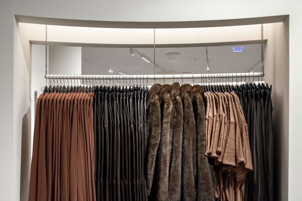 Rayons vêtements du magasin H&M Rosny avec portants, cloison translucide et éclairage retail