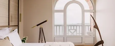 Chambre de l’hôtel Les Bassans à Perros-Guirec avec mobilier sur mesure, télescope et vue mer