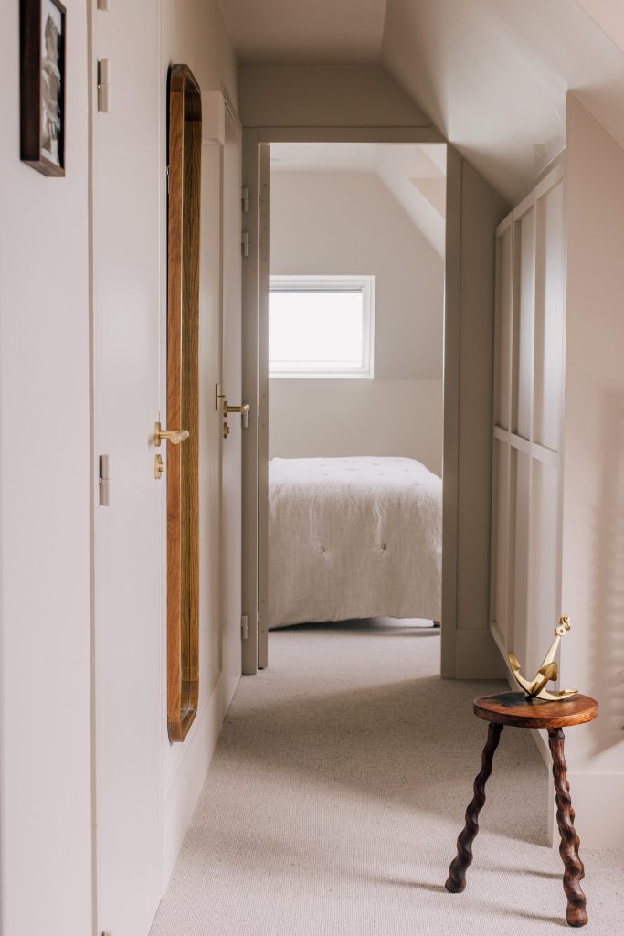 Couloir d’une chambre de l’hôtel Les Bassans avec mobilier bois, tons clairs et ambiance feutrée
